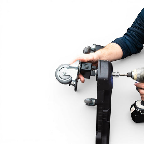 Willey Quick Glideator Caster Upgrade Kit being installed onto a black tool case with a drill. Features wide stance, dual-locking casters.