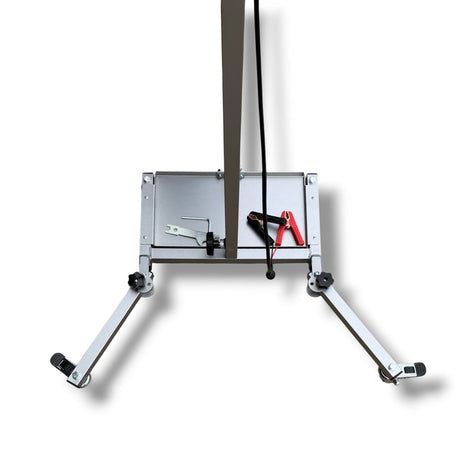 Anson PDR Econo Light Stand base with adjustable legs, battery tray, and cable clips. Silver aluminum construction.